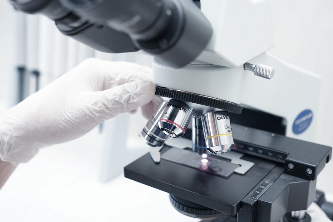 scientist examining microscope slide