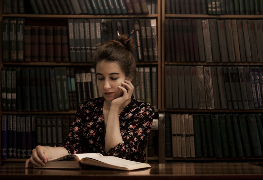 person reading old books in library
